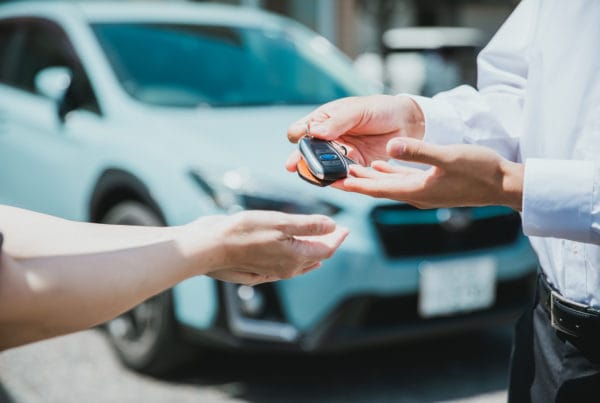 Manager handing over keys to employee