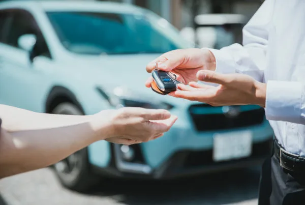 Manager handing over keys to employee