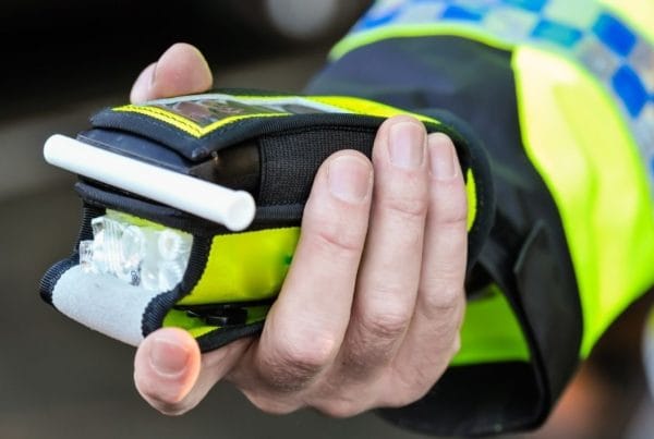 Police officer holding breathalyser