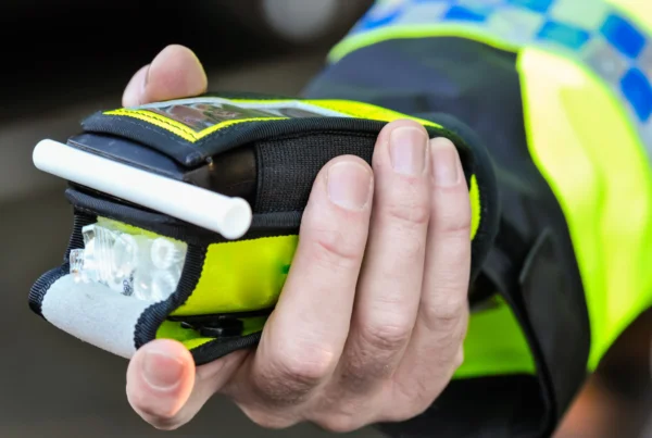 Police officer holding breathalyser