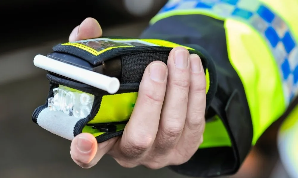 Police officer holding breathalyser