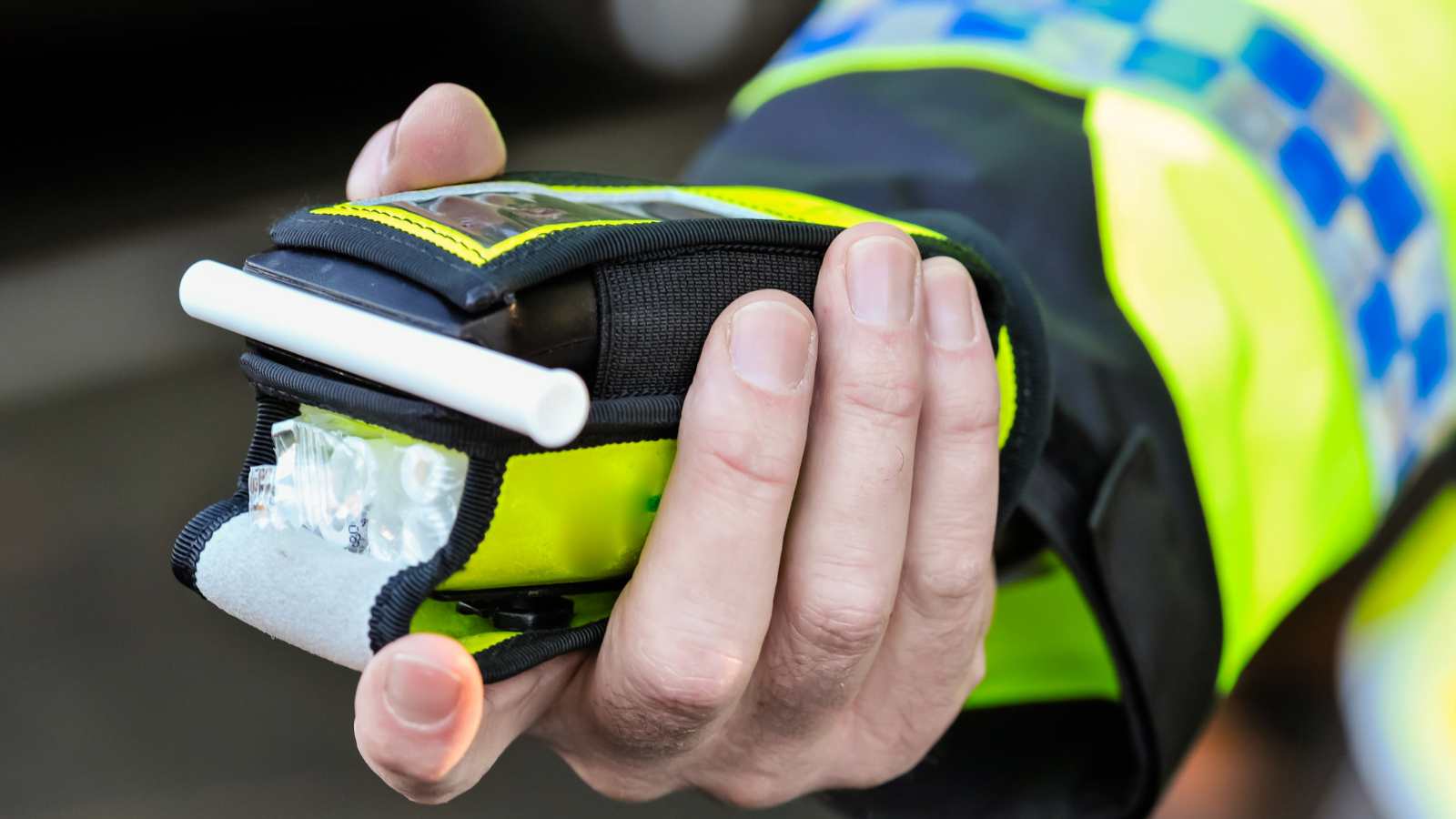 Police officer holding breathalyser