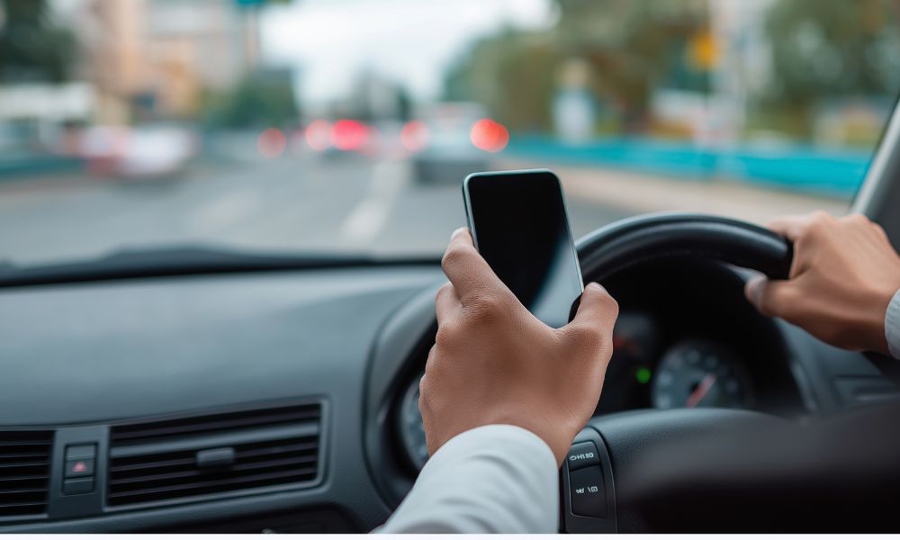 Man illegally checking phone whilst driving