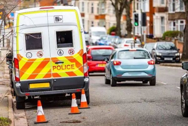 Police van parked at the side of a residential road.