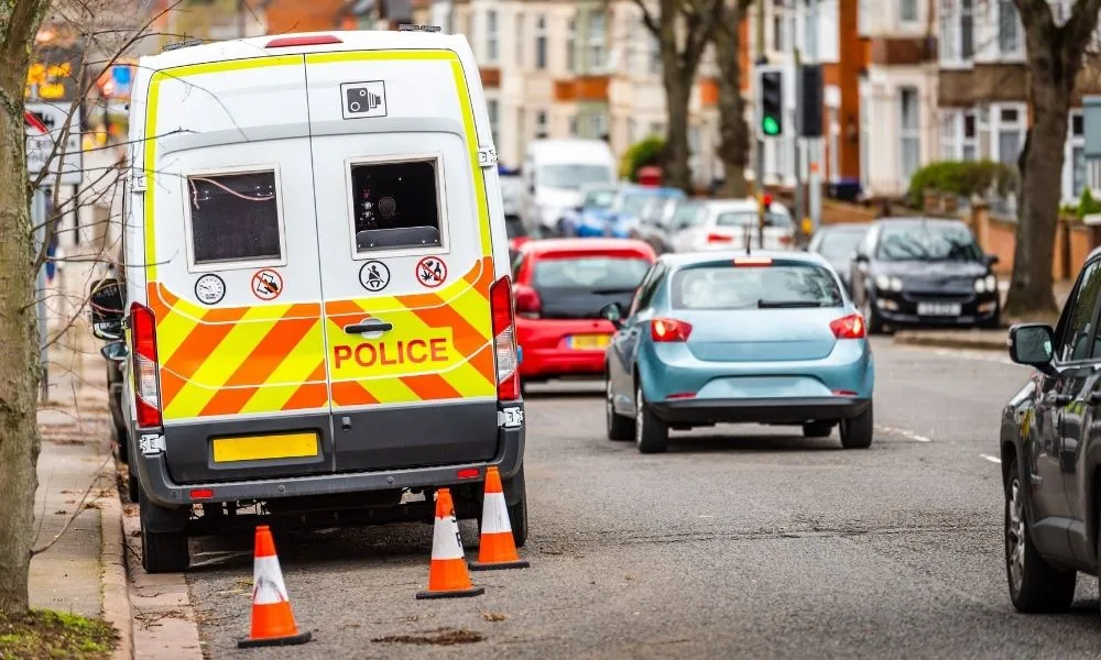 Police van parked at the side of a residential road.