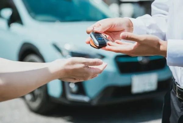 Manager handing over keys to employee