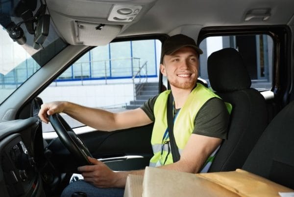 Smiling driver sitting at the wheel of a van