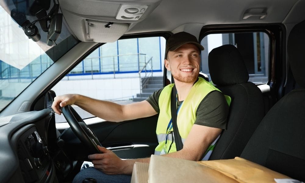 Smiling driver sitting at the wheel of a van