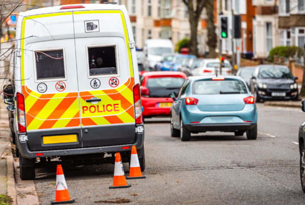 Police van parked at the side of a residential road.