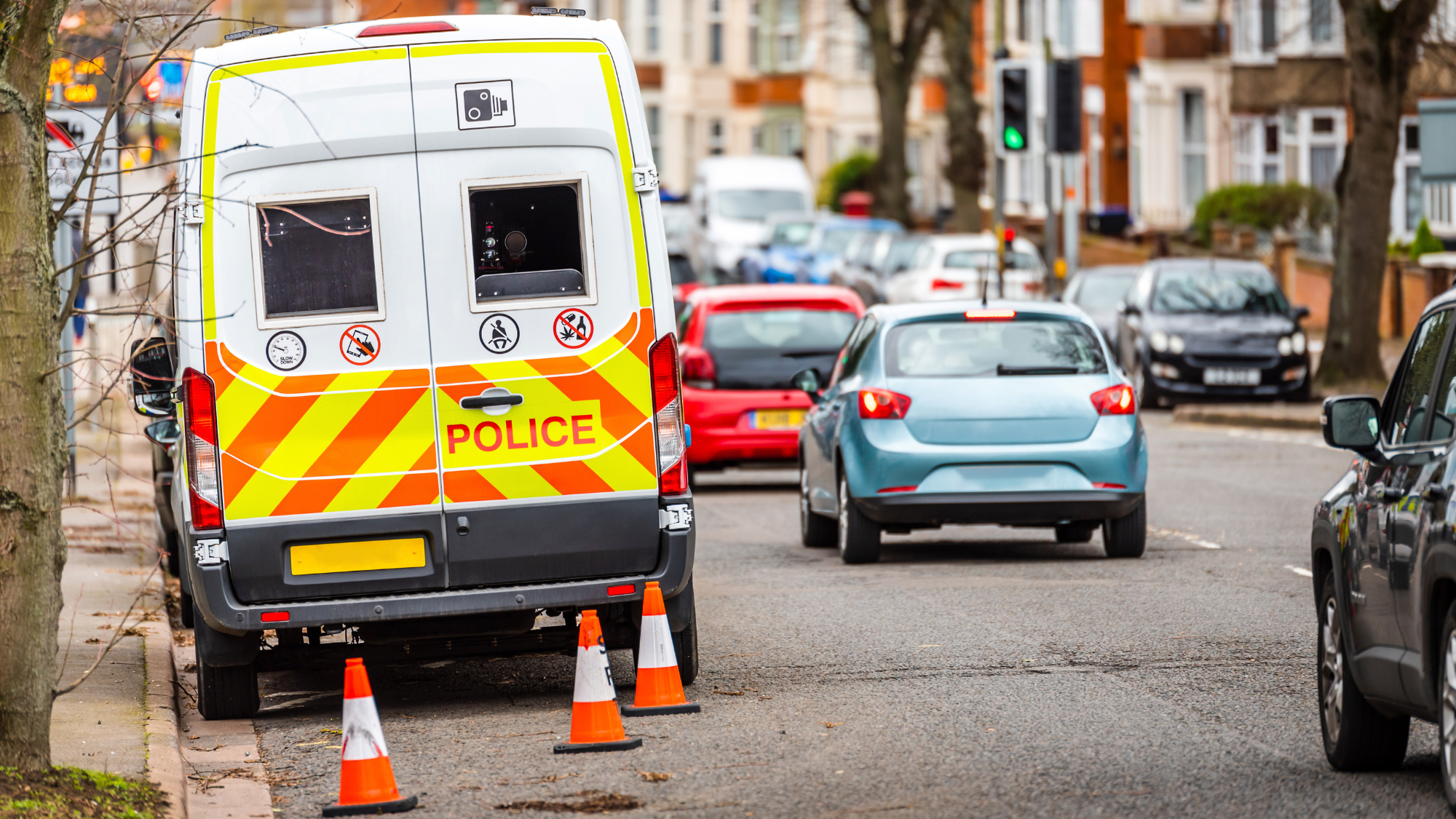 Police van parked at the side of a residential road.